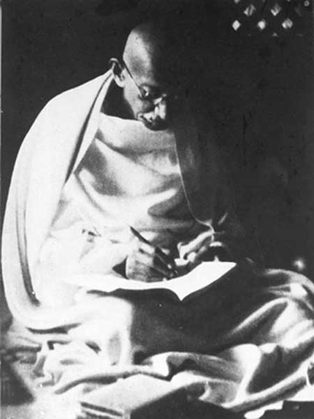 Gandhiji attending to some write up during his Noakhali tour.jpg